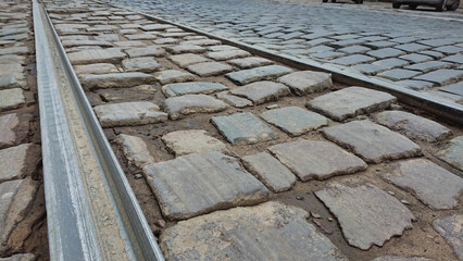 Stone-paved street with tram rail close-up