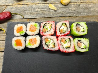 sushi on a granite board on a wooden table background