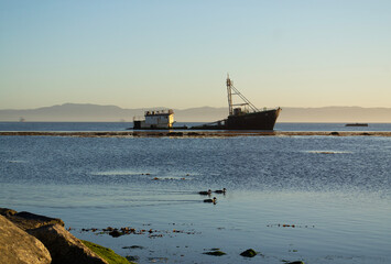 A ship stranded near a seawall on the coast of Chile
