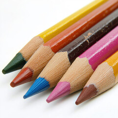 Fototapeta premium Colorful arrangement of colored pencils on a white surface showcasing vibrant hues and sharp tips for artistic creativity