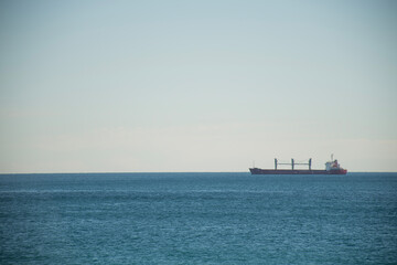 cargo ship in calm sea and clear cloudless day logistics international trade