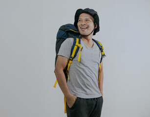 Portrait happy smiling asian man tourist holding backpack looking away and feels satisfied happy isolated on white background. Travel and tourism concept.