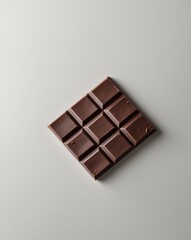 Obraz premium a chocolate bar with six square pieces showcasing a smooth glossy surface