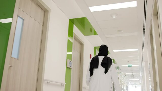 An Arab doctor walks in the hospital corridor