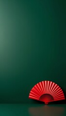 Elegant Red Hand Fan Against a Deep Green Background Minimalist Design Aesthetic Photography