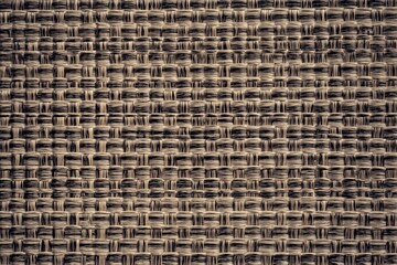 Woven straw mat texture showcasing intricate patterns in natural beige tones
