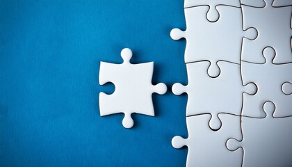 Obraz premium Puzzle pieces - Last piece of white puzzle ready to complete the mission on blue background