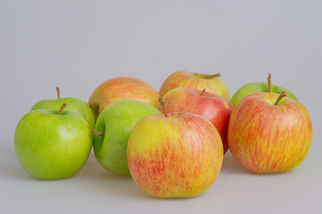 Fruits red and green apples on a gray background.