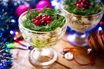 Festive salad for Christmas and New Year. Salad with peas, vegetables and meat in beautiful plates on a wooden table. Home cooking: Olivier in glass plates for the new year. Close-up