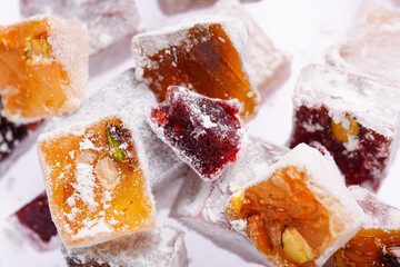 Sweet food Turkish delight, assorted rahat locum in form of cubes with nuts and powdered sugar, traditional food, on white background