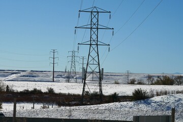 Snowy prairie overhead power lines in Colorado