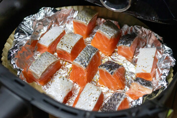 Delicious salmon fillets cooking in foil. Healthy and easy meals from air fryer.