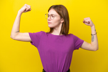 Young English woman isolated on yellow background doing strong gesture