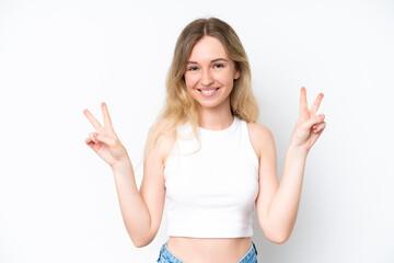 Blonde English young girl isolated on white background showing victory sign with both hands