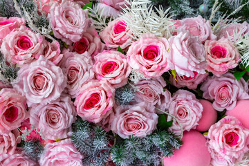 New Year composition with artificial roses and fir tree branches.