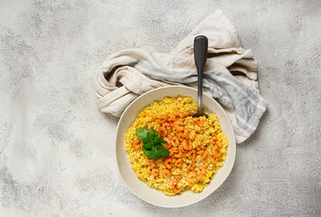 risotto with shrimp, in a bowl, on a textured surface, with a side dish of fresh coriander, homemade, no people,