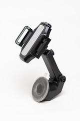 Car smartphone holder on a white background. Car suction cup holder for mounting on the windshield.