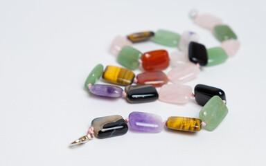 Close-up of beads with large rectangular beads made of shiny natural stone. Jewelry made of natural materials.