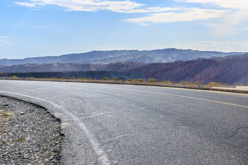 Asphalt road and mountain nature landscape under blue sky. Outdoor road background.
