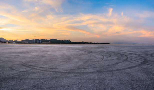 Asphalt road square and coastline with beautiful sky clouds nature landscape at sunset. Outdoor asphalt parking lot.