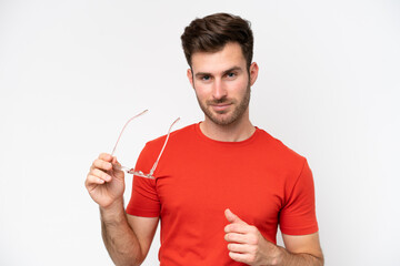 Young caucasian man isolated on white background With glasses with happy expression