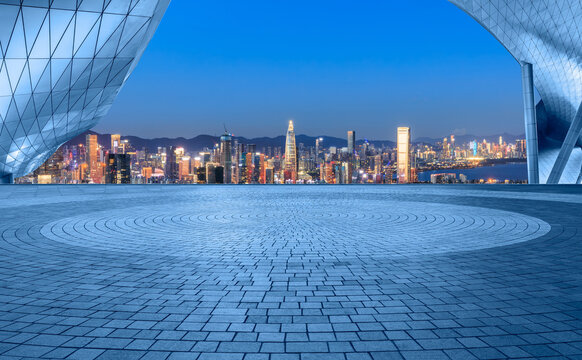 Empty square floor and city skyline with modern buildings scenery at night in Shenzhen, China. Outdoor city background