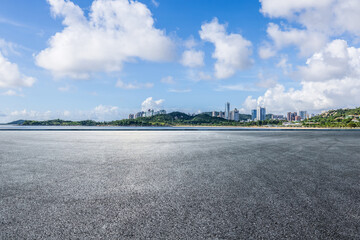 Asphalt road square and city skyline with island scenery in Zhuhai, China. Outdoor asphalt parking...