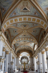 The inside of a large church with a high ceiling and gold accents