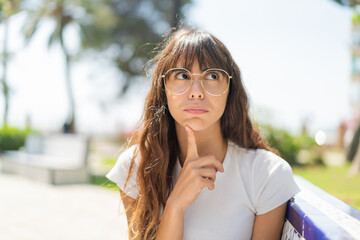 Young woman at outdoors With glasses and looking up