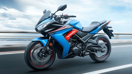 A blue motorcycle speeding on a road with a blurred background, showcasing its design and agility.