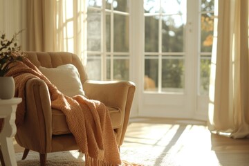 A cozy armchair draped with a warm throw blanket, bathed in sunlight by a window.