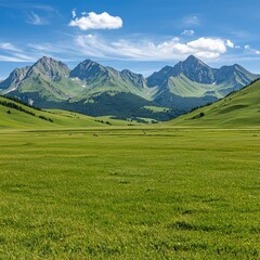 Obraz premium A stunning landscape featuring lush green meadows and majestic mountains under a clear blue sky with fluffy clouds.