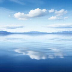 Fototapeta premium A serene landscape featuring calm water reflecting blue skies and fluffy clouds, creating a tranquil and peaceful atmosphere.