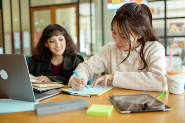 Friends Studying Together at a Cafe Working on Academic Projects