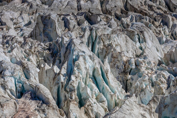Glacier le Bossons in the french Alps, Chamonix valley, Montblanc. The glacier crevasse and huge serac with blue ice on slopes of Mont Blanc. Melting glacier caused by climate change global warming