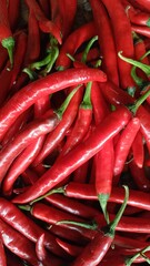 A vibrant pile of fresh red chili peppers, ready to be used in cooking.