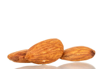 Fragrant roasted almonds, close-up, isolated on white background.