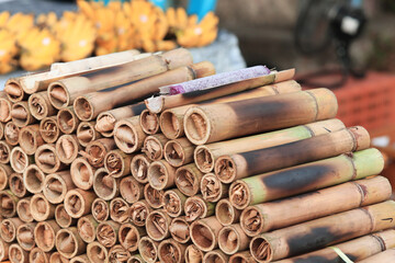 close up pile of Khao Lam for sale at local marke, Khao Lam is Thai food made from glutinous rice roasted in bamboo joints
