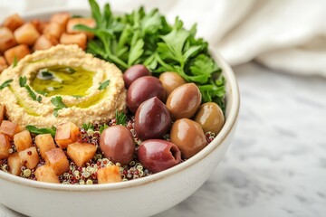 Quinoa grains inspire healthy recipes. Vibrant bowl of quinoa, hummus, olives, and fresh greens.