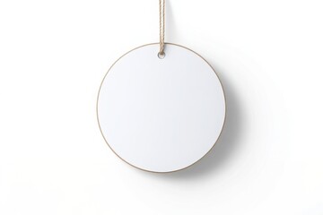 Circular white tag with twine loop ready for labeling various items in clean, minimalist design