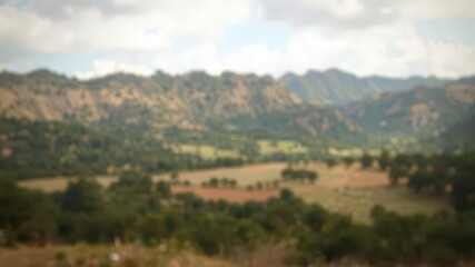 Fototapeta premium Woven fabric texture overlaid on a blurred natural landscape, art,landscape