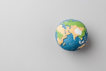 A simple silhouette of Earth in black and white, focusing on recognizable continent outlines