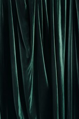 Textured green velvet fabric drapes elegantly.