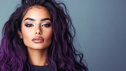 A stunning portrait of a woman with voluminous purple hair surrounding her face, complemented by glowing skin and soft makeup, symbolizing beauty and creativity.