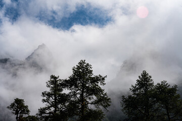 Fototapeta premium Cloudy and Foggy Mountain Peaks of Himalayas