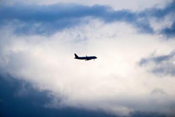 Modern Passenger Aircraft Arrival during Dramatic Evening Sky