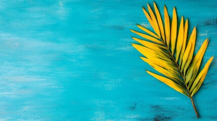 A yellow palm leaf on a blue background