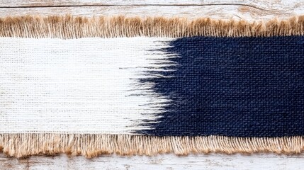 A blue and white rug with fringes on a wooden surface
