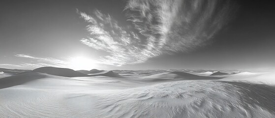 Black and white snowy landscape with dramatic clouds.