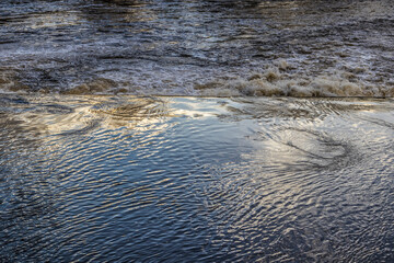 Abstract view of cloud reflections on surface of river